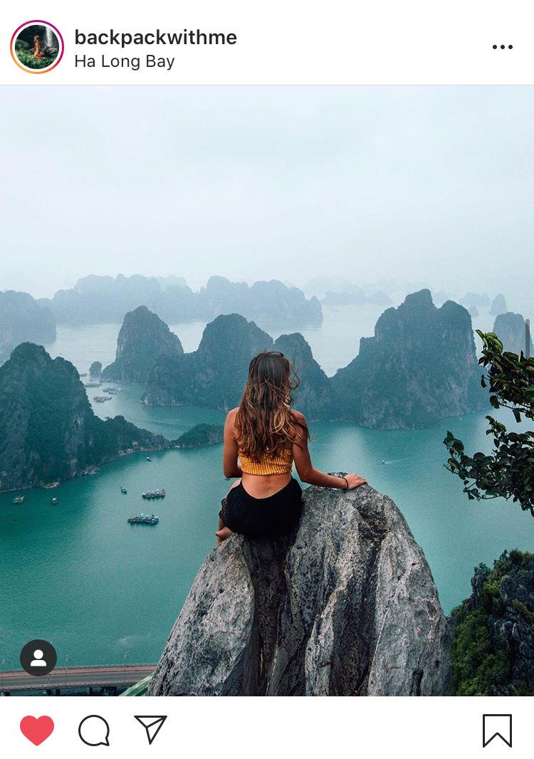 Girl sat on rock overlook halong bay in Vietnam