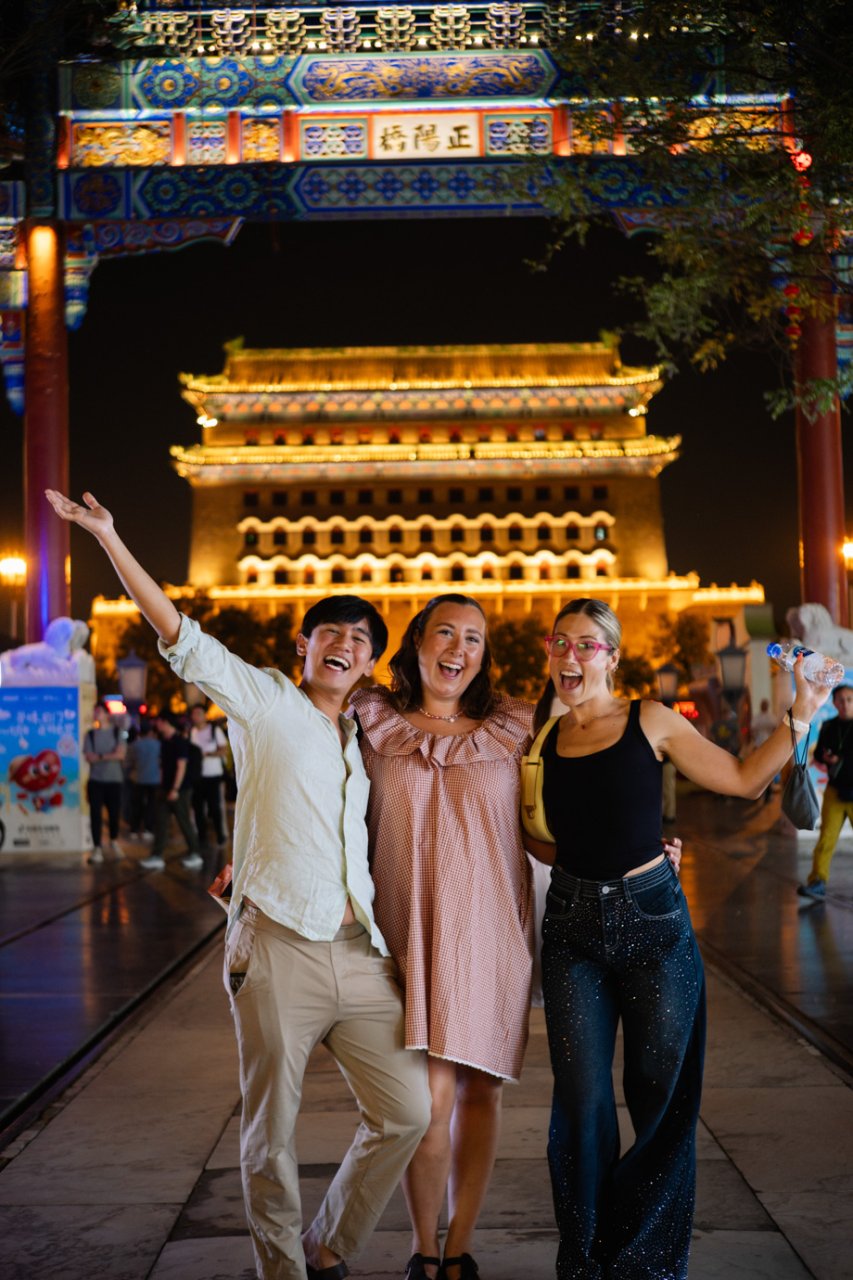 Three travellers celebrating being in China on their first night of a TruTravels trip
