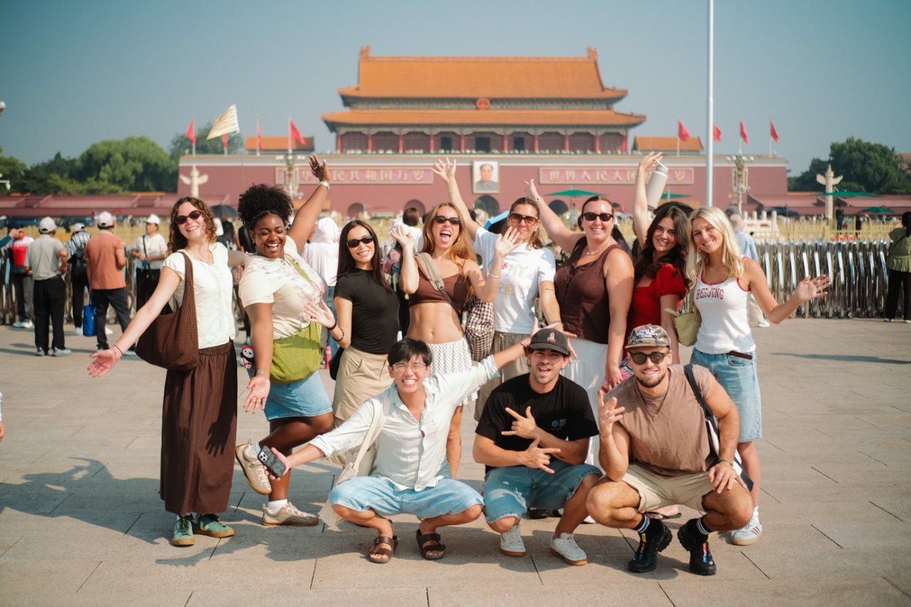 Group tour posing in Tiananmen Square in front of the Gate of Heavenly Peace in Beijing