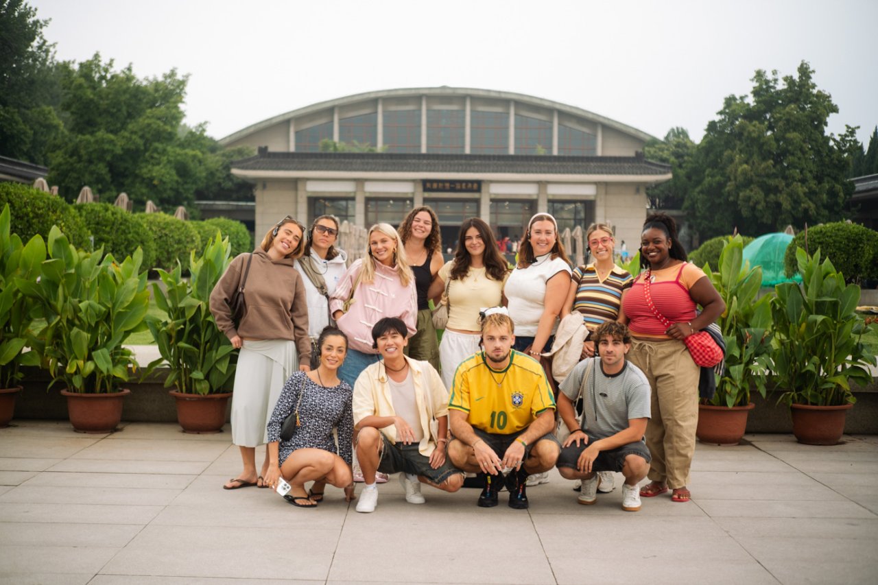 Tour group posing outside the Terracotta Warriors museum hall in Xi'an