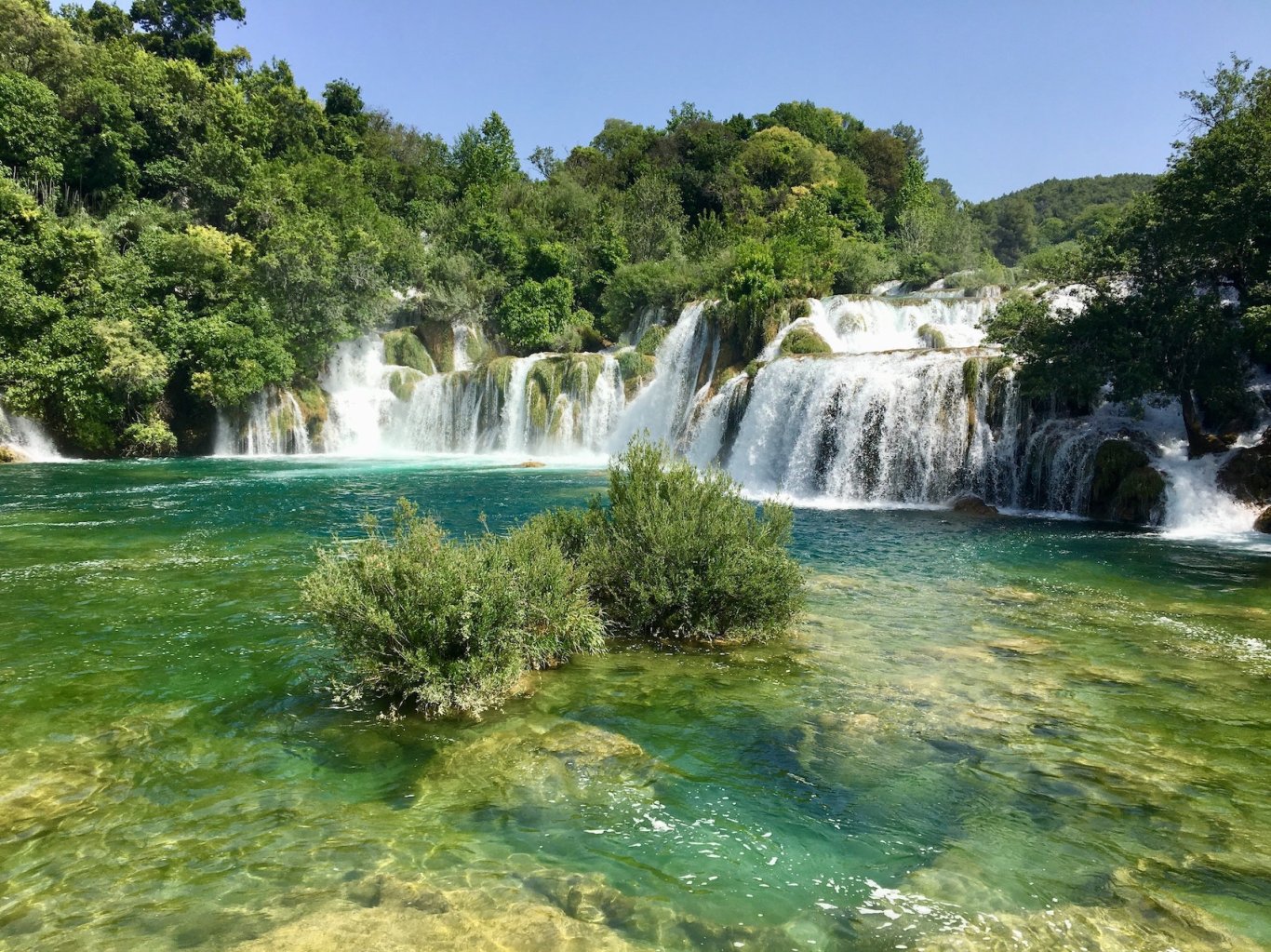 Krka National Park in Croatia waterfalls showing bright turquoise water and amazing greenery