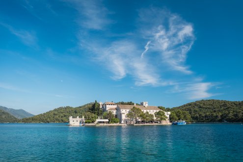 The picturesque island of Mljet, Croatia showing the clear blue water and a house in the distance. 