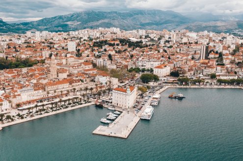 Aerial view of Split, Croatia showing the port, beautiful mountain landscape and the terracotta roofs of Split