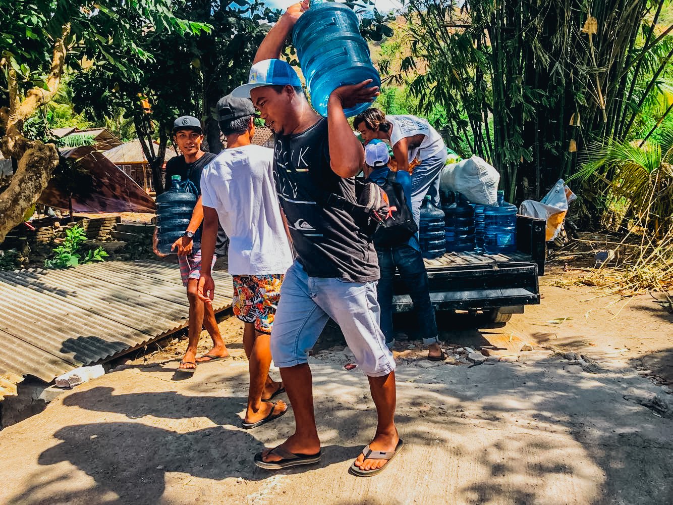 loading food into van to help the locals of lombok