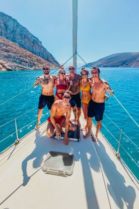 A group of 6 on the sail boat while sailing around the stunning Greek islands