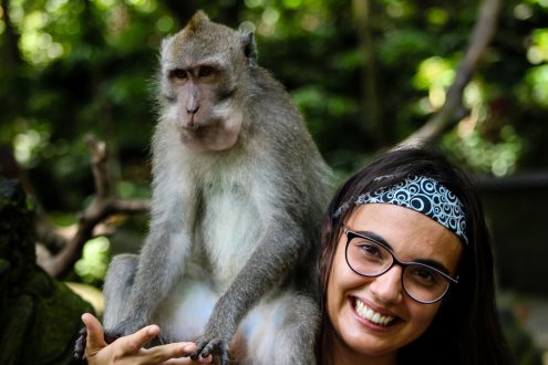 Girl smiling with monkey on her shoulder