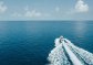 A drone shot of the boat in the Maldives sailing into the distance A