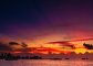A scenic shot of a gorgeous golden orange and pink sunset in the Maldives 
