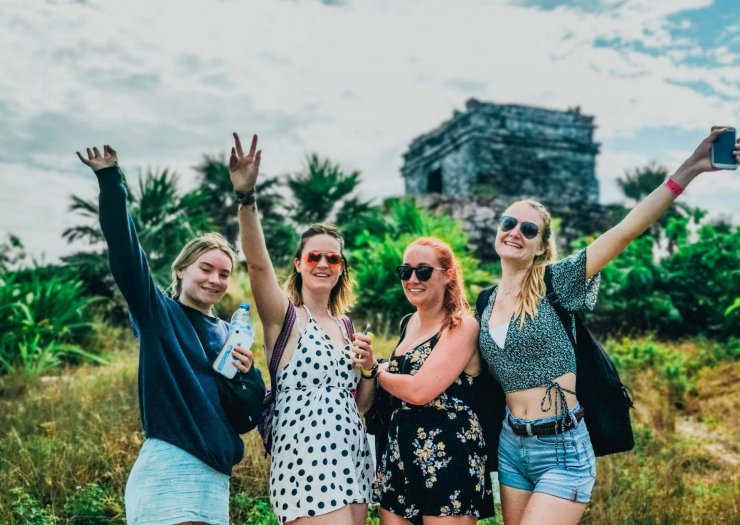 A group of people stood in front of the Tulum Ruins.