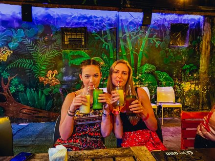 A pair enjoying drinks at a vibrant bar.