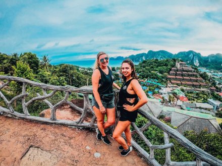 Two girls standing at a viewpoint overlooking islands in the background in PhiPhi, Thailand