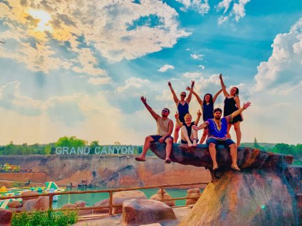 Group sitting on rock outside the Grand Canyon waterpark in Chiang Mai, Thailand