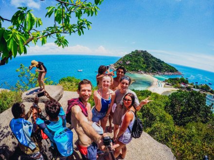 group taking selfie at Koh Nang Yuan with islands in distance and blue water and sky
