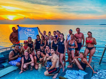 A group photo in front of the serene sunset in Koh Phangan