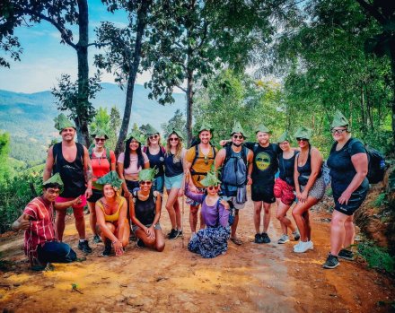 A group hiking in Chiang Mai Thailand wearing hats made out of banana leaves