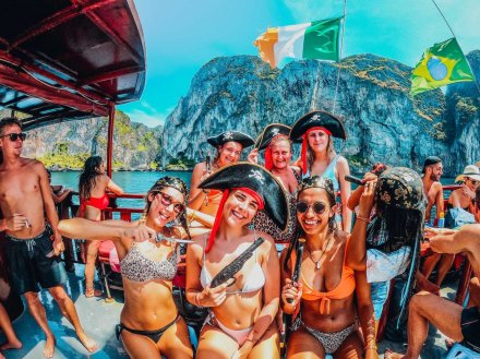 Girls on a boat party wearing pirate hats while Island hopping in Koh Phi Phi Thailand 