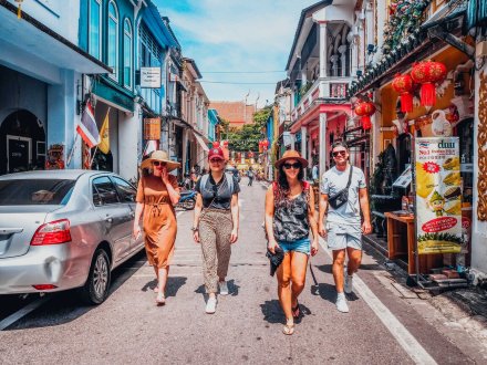 A group of four walking through the streets of Phuket, Thailand 