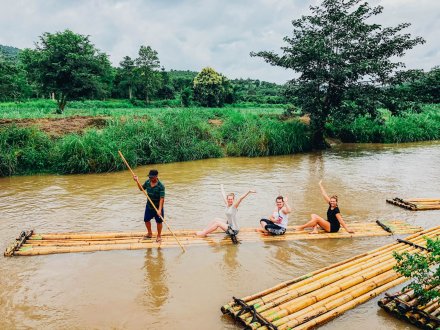 A group photo on a bamboo raft going along the river in Northern Thailand