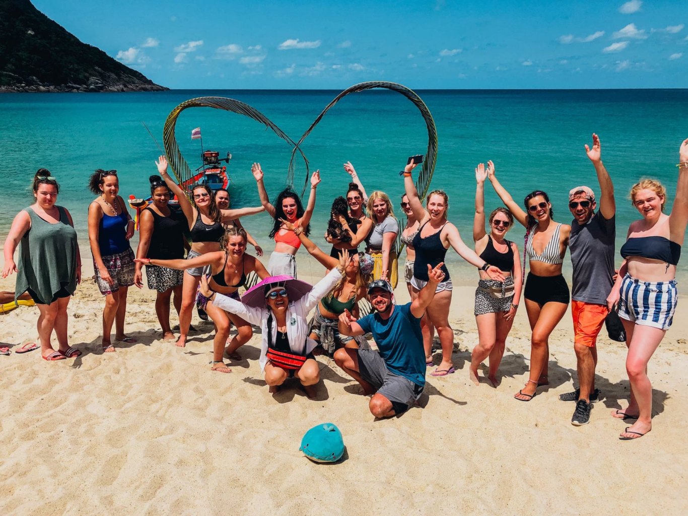 A group photo in front of the blue ocean at bottle beach in Koh Phangan Thailand