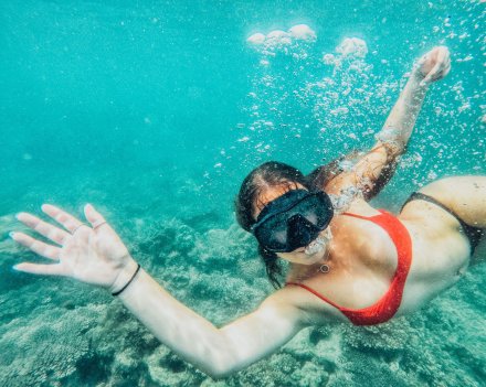 A girl snorkeling in the crystal clear water in Koh Phi Phi Thailand 