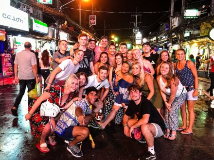 A group taking in the nightlife Phuket has to offer during the island hopper in Thailand 