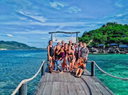 A group photo by turquoise water in Koh Tao