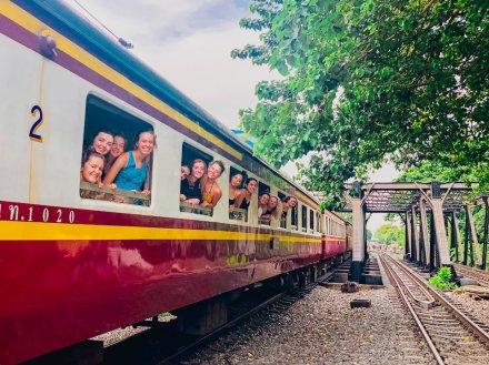 A group photo from the windows on the overnight train to Khao Sok National Park Thailand