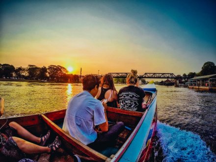 Admiring the sunset over the river Kwai from a long tail boat in Kanchanaburi Thailand 