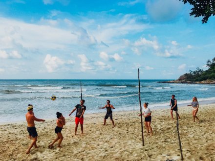 A group playing volleyball on the beach in Thailand Koh Tao