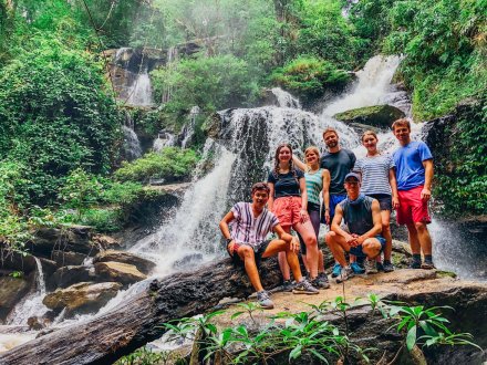 A group photo by the waterfall during the jungle trek in Chiang Mai Thailand 