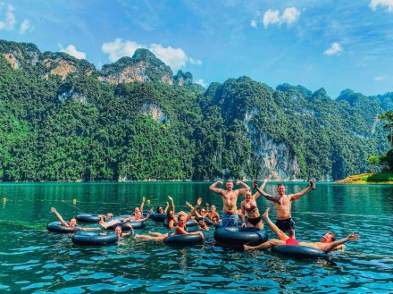 Group photos on the doughnuts in front of beautiful mountains in Khao Sok Thailand 